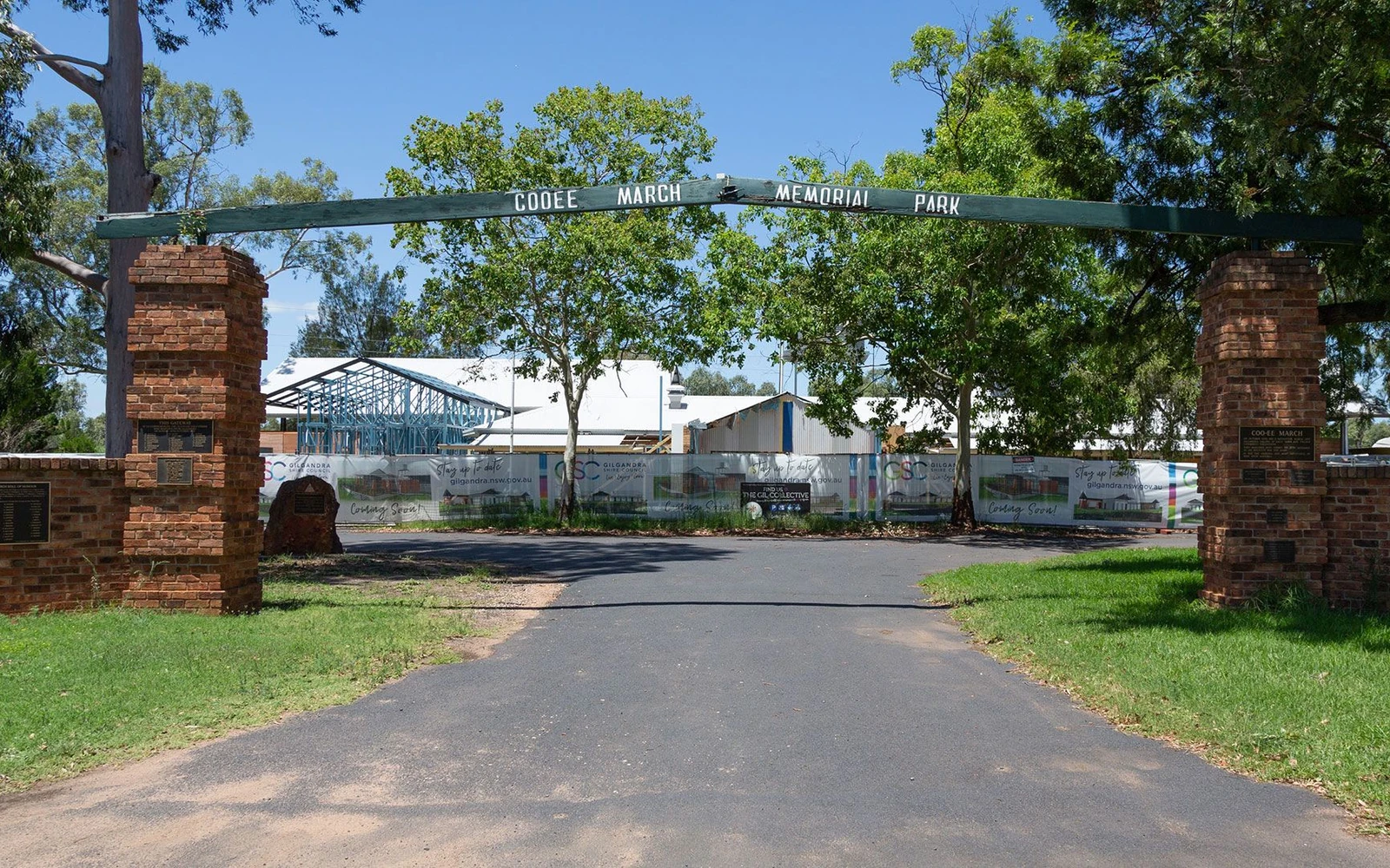Brick entry gates and timber arch at Coo-ee March Memorial Park in Gilgandra